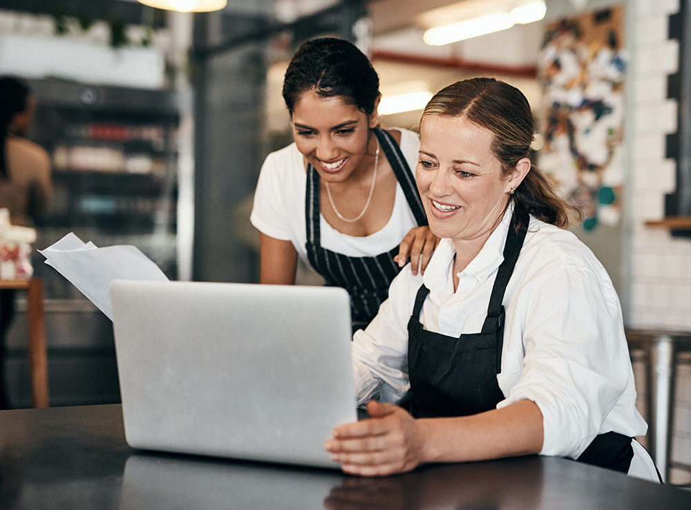Zwei Frauen machen das Backoffice in ihrem Kaffee.
